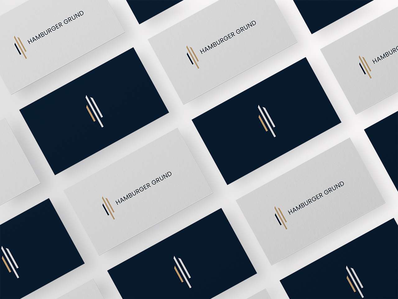 Business cards from Hamburger Grund arranged in a grid, alternating white and black versions with symbol and logo