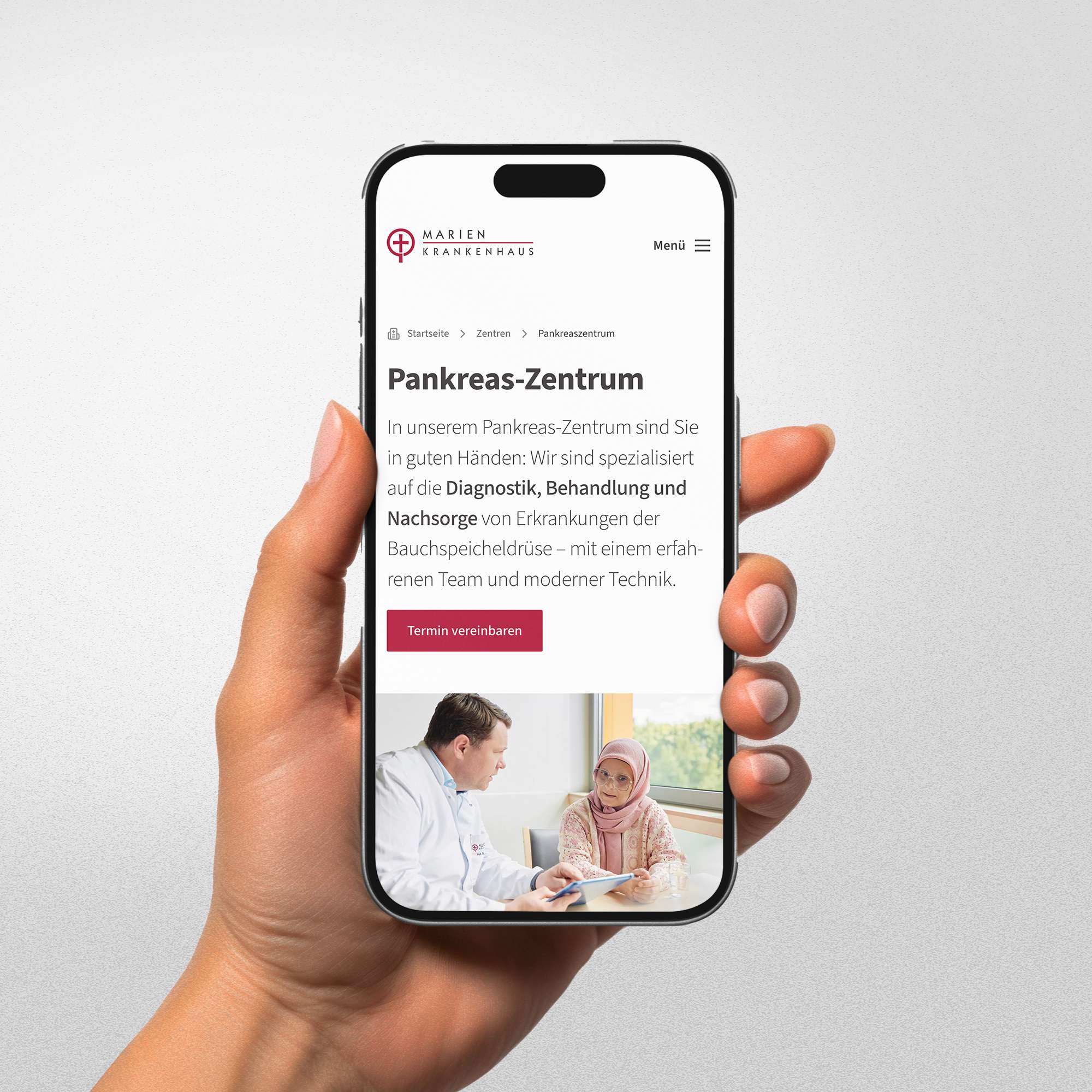 Female hand holding a smartphone displaying a website for the Pancreas Centre.