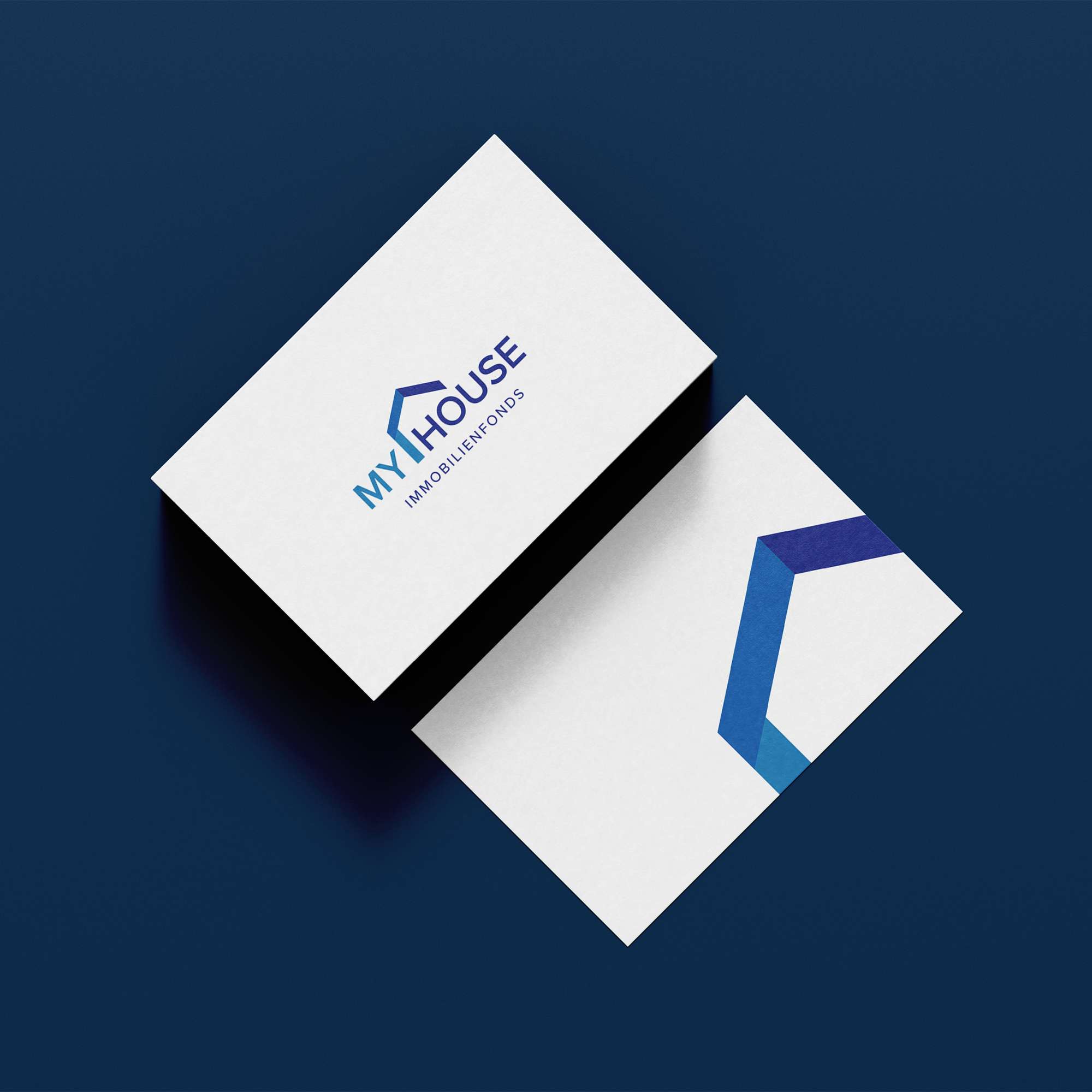 Mockup of the My House business card in front and back view showing the logo and symbol