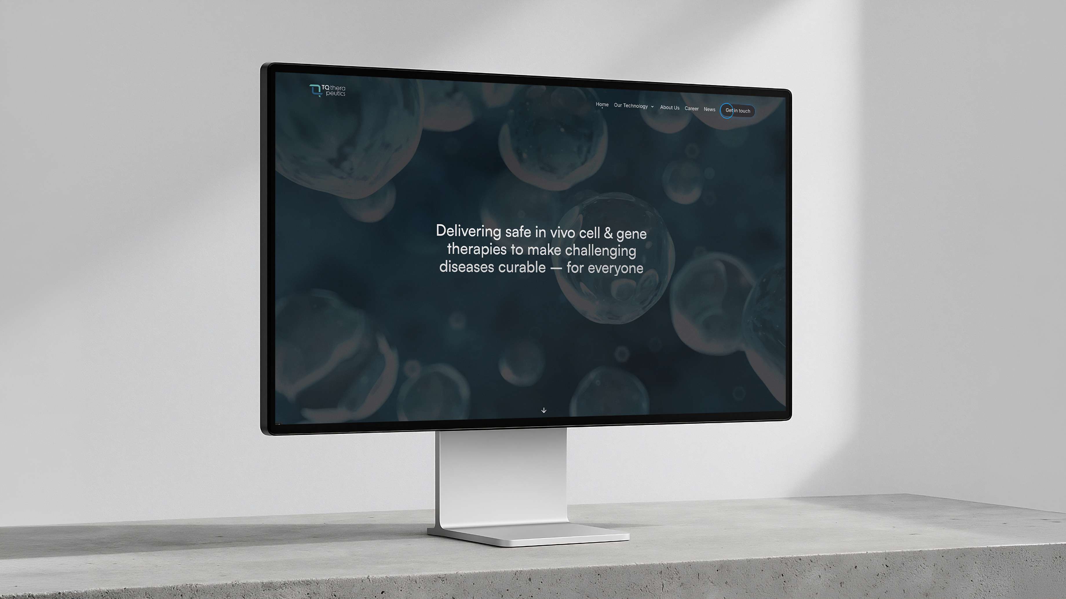 A modern monitor stands on a table, displaying a dark screen with the following text: “Delivering safe in vivo and gene therapies to make challenging diseases curable – for everyone.”